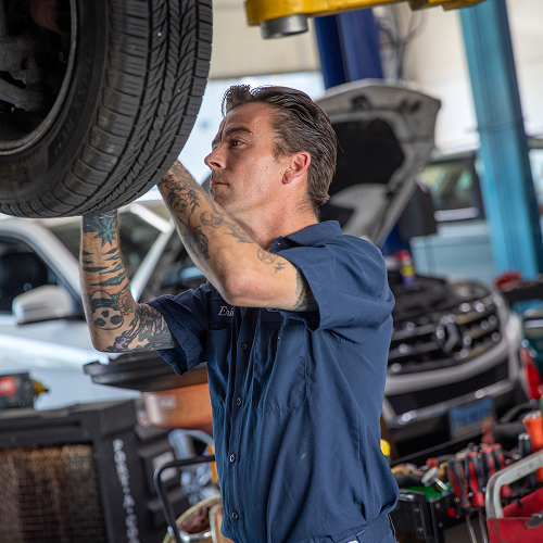 Mechanic with wrench icon on a blue to red gradient background. | Bavarian Auto Haus