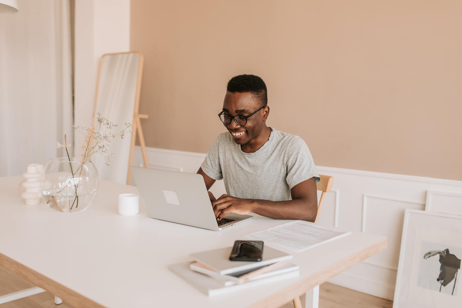 Smiling man typing on laptop