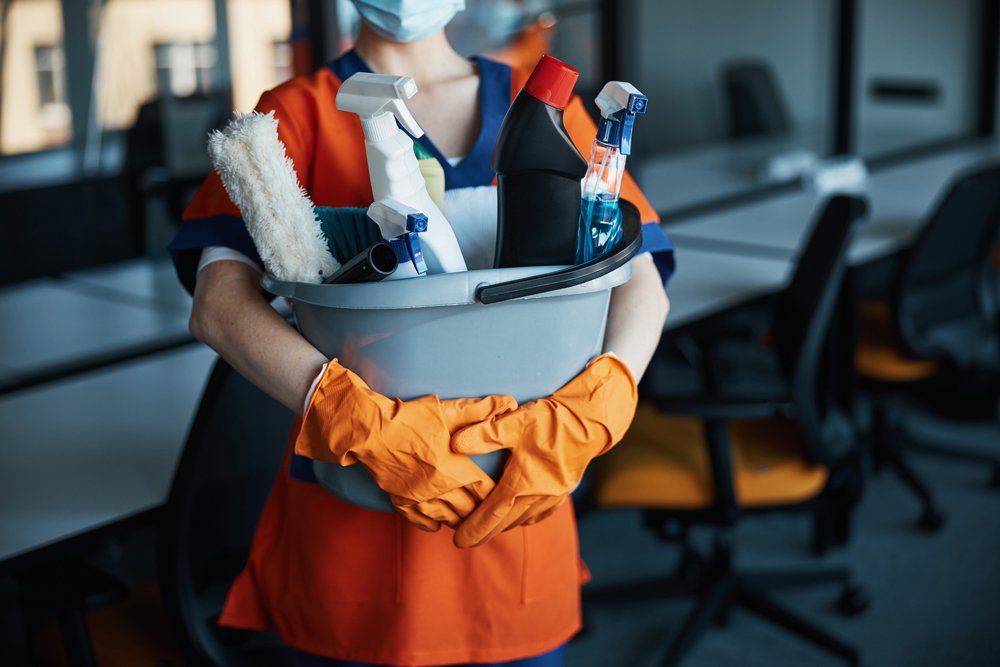 Woman Holding a Plastic Bucket with Cleaning Products — Kansas, MO — Crum Cleaning