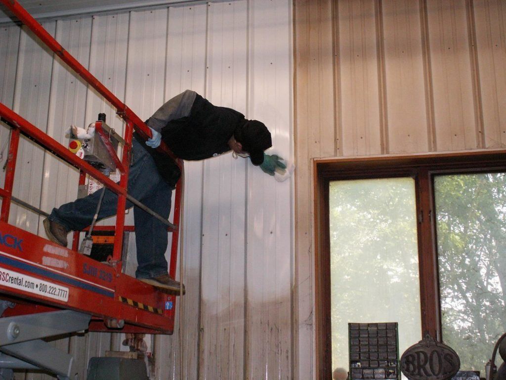 Man Cleaning Warehouse Wall — Kansas, MO — Crum Cleaning