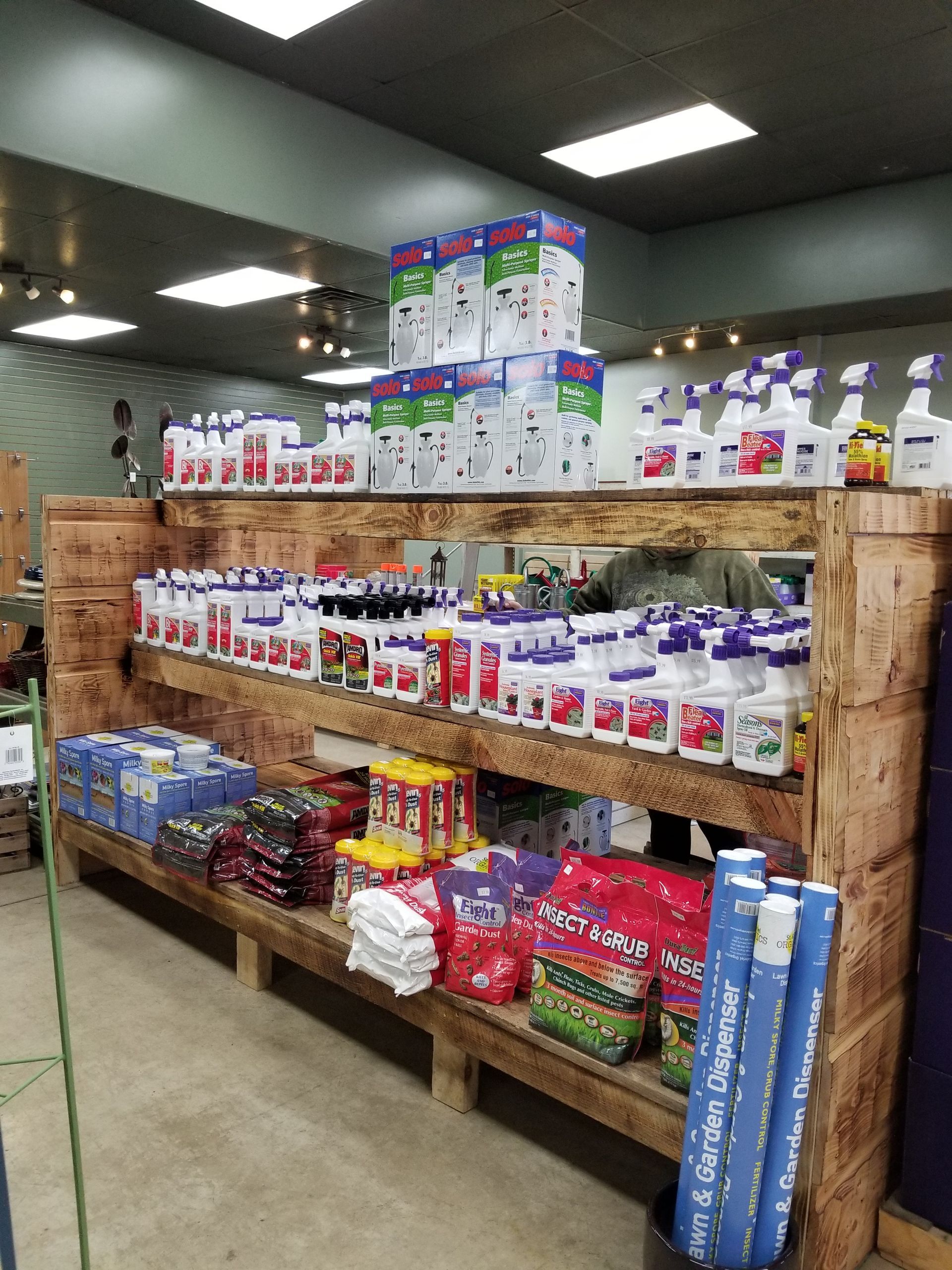 Store shelves stocked with assorted groceries and household goods in a warehouse aisle