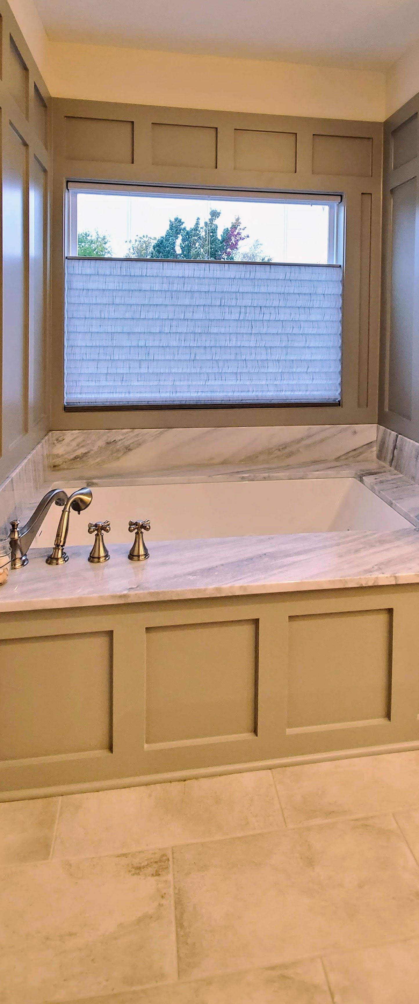 Solar Shield Honeycomb Shades installed over a primary bathtub. Top Down Bottom Up