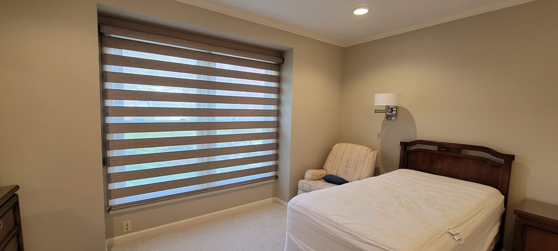 light dimming Solar Shield Banded Shade installed in primary bedroom
