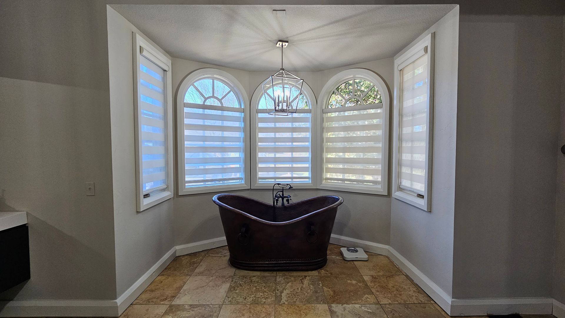 Primary bathroom with Solar Shield Banded Shades installed on windows
