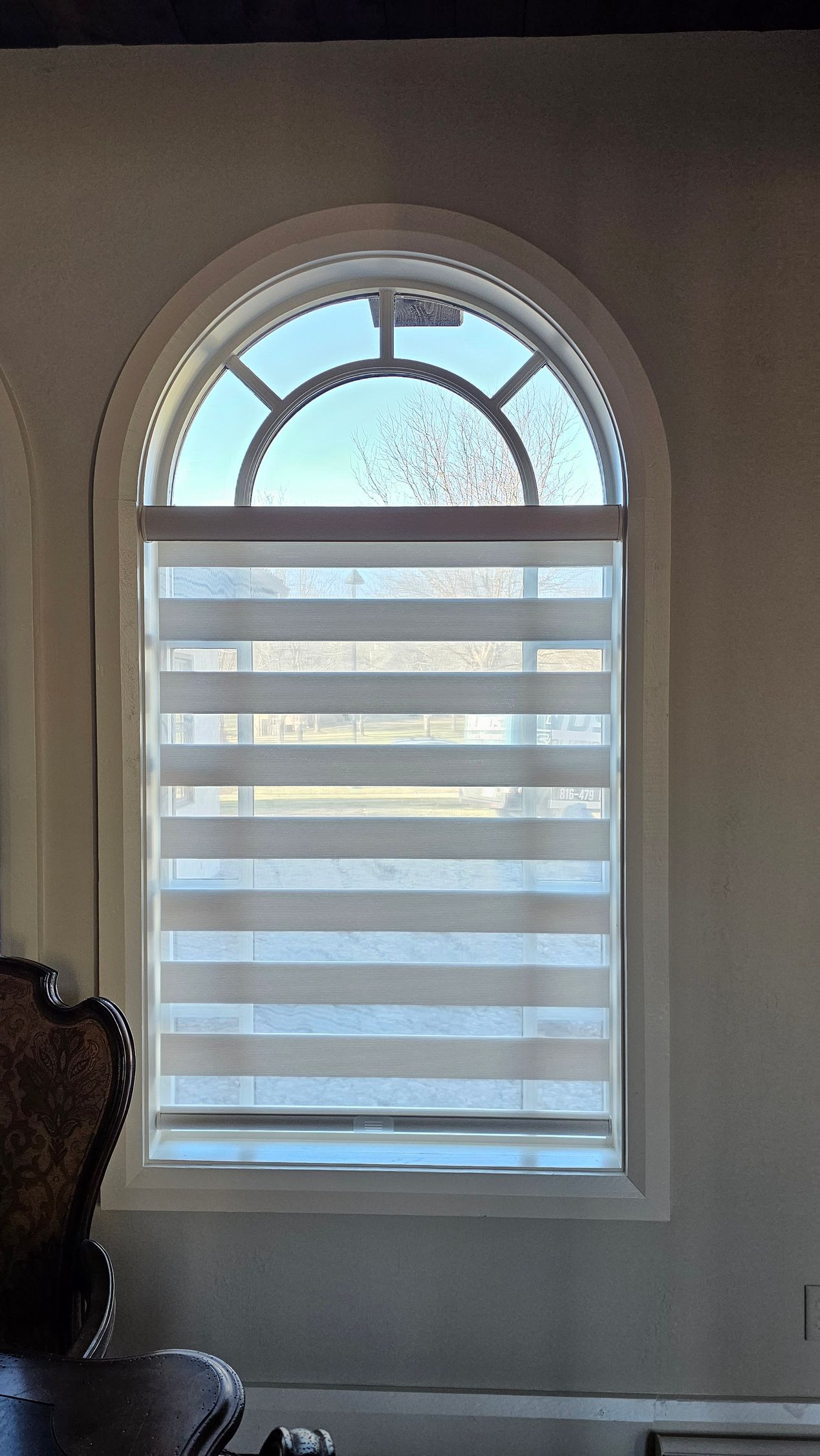 Solar Shield Banded Shade installed below arch window