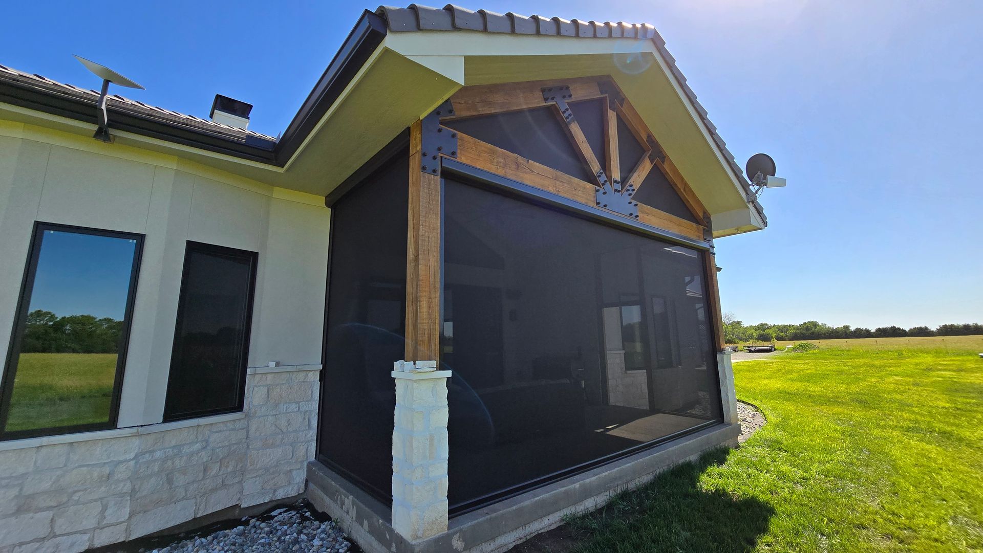 Outdoor patio with Solar Shield screens installed on large openings and upper triangle openings