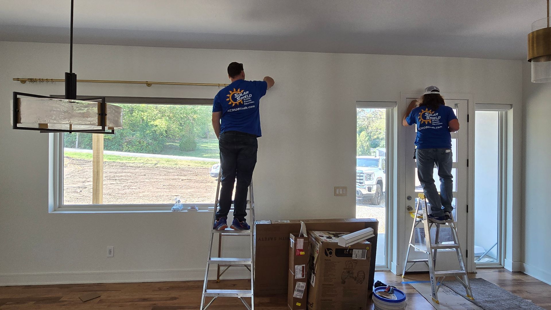 Solar Shield installers installing drapery hardware and roller shade hardware