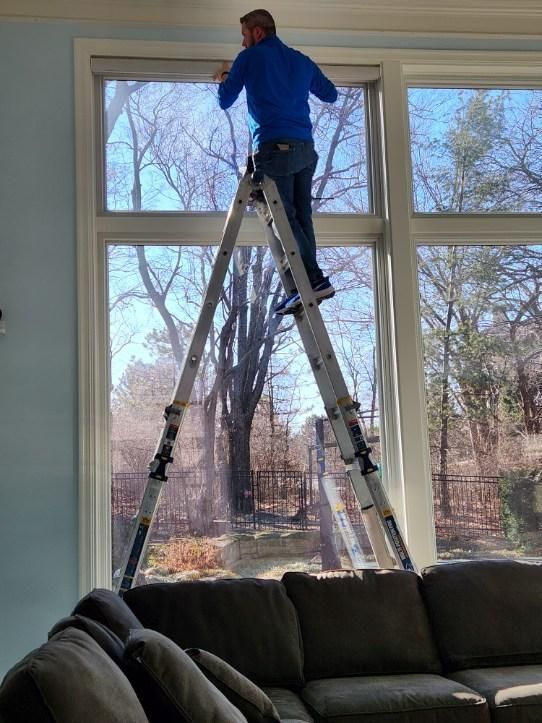 Solar Shield installer working on automated roller shade in Kansas City