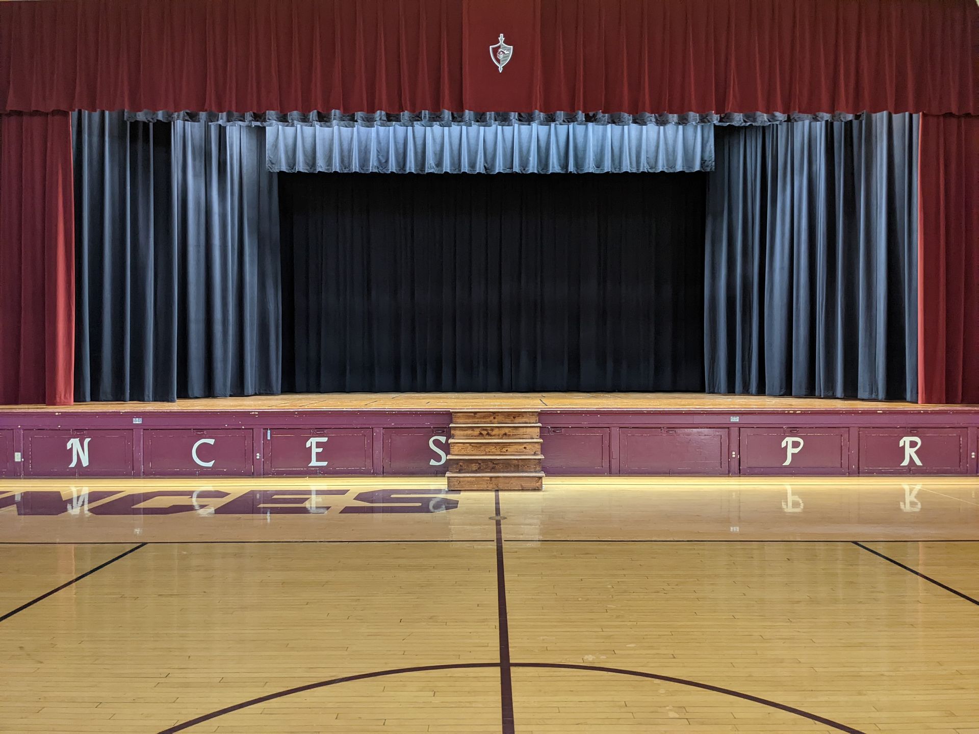 Solar Shield Stage Curtains installed in a school gymnasium
