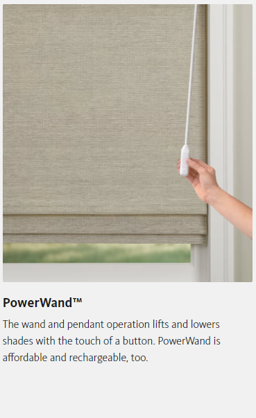 A person is holding a button on a roman shade.