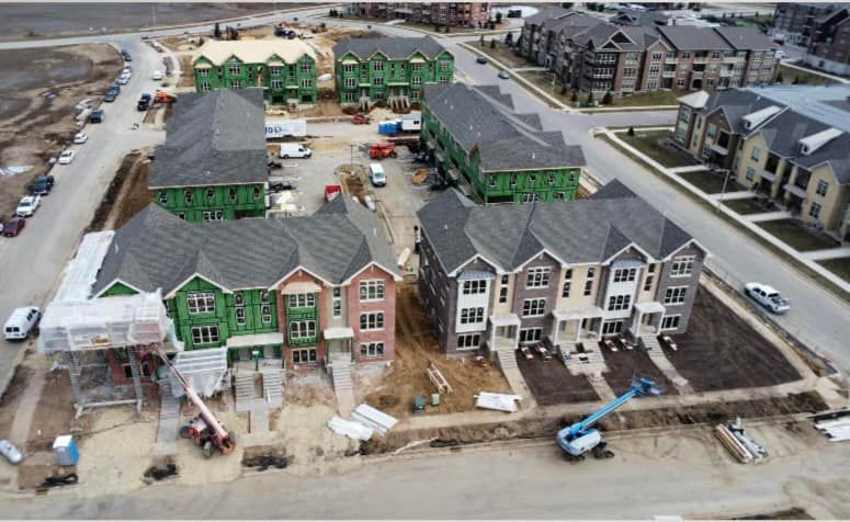An aerial view of a row of houses under construction