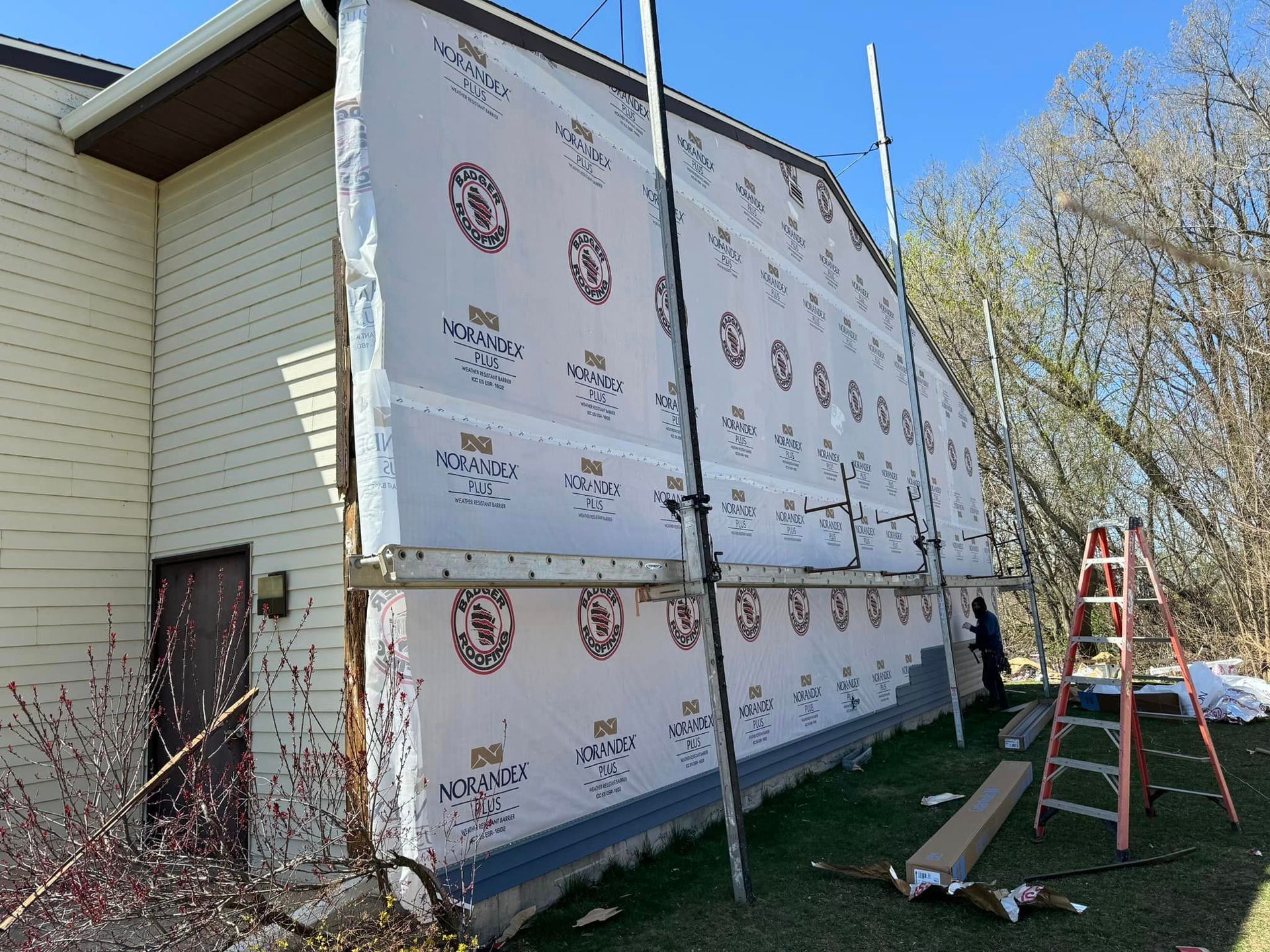 A house with a lot of siding on it is being remodeled.