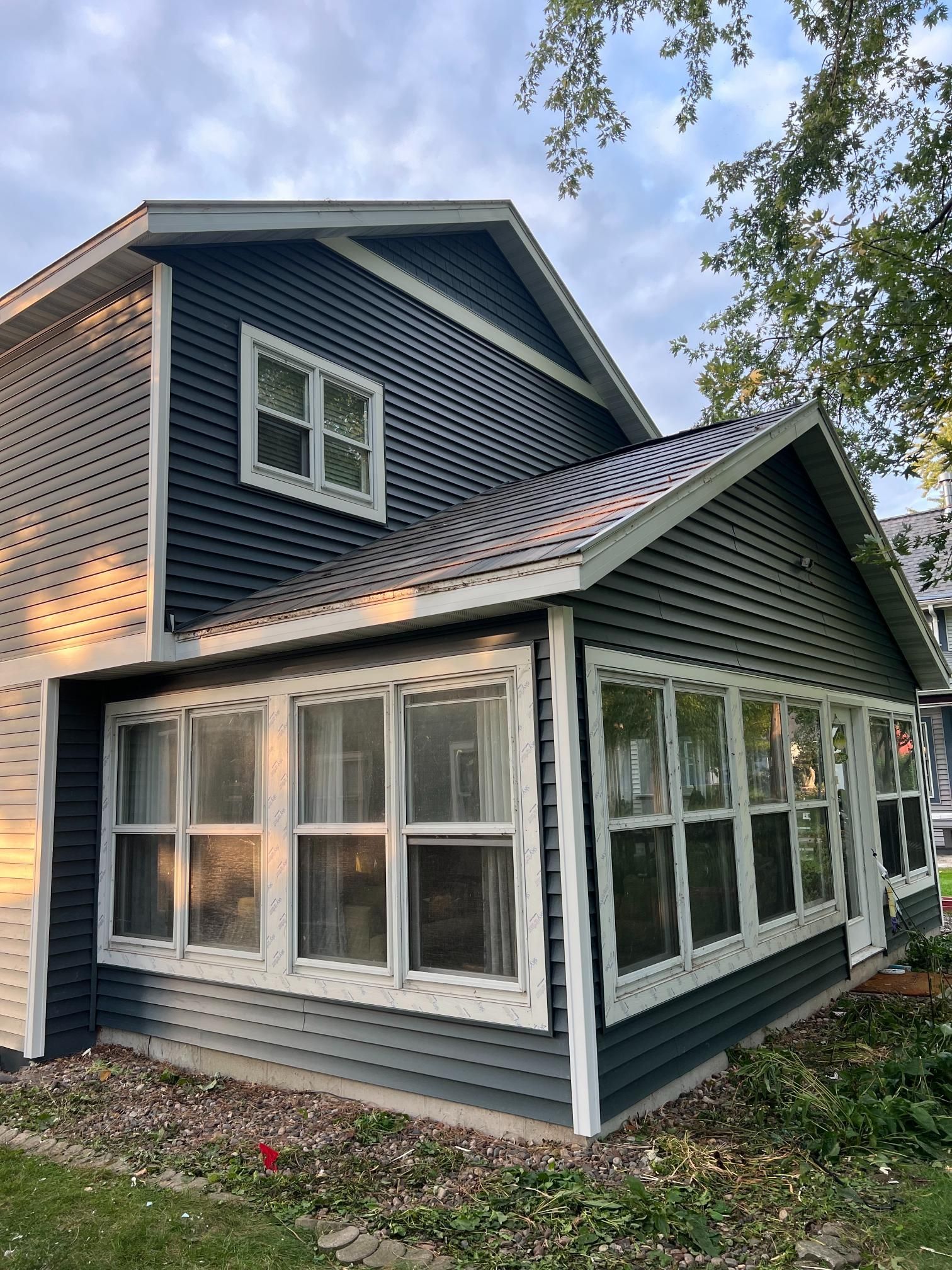A large house with two cars parked in front of it
