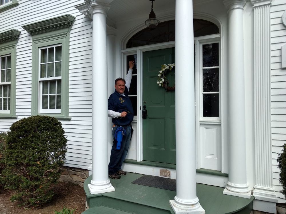 Owner Cleaning Outdoor Window — Hadley, MA — Family Window Cleaning & Property Maintenance