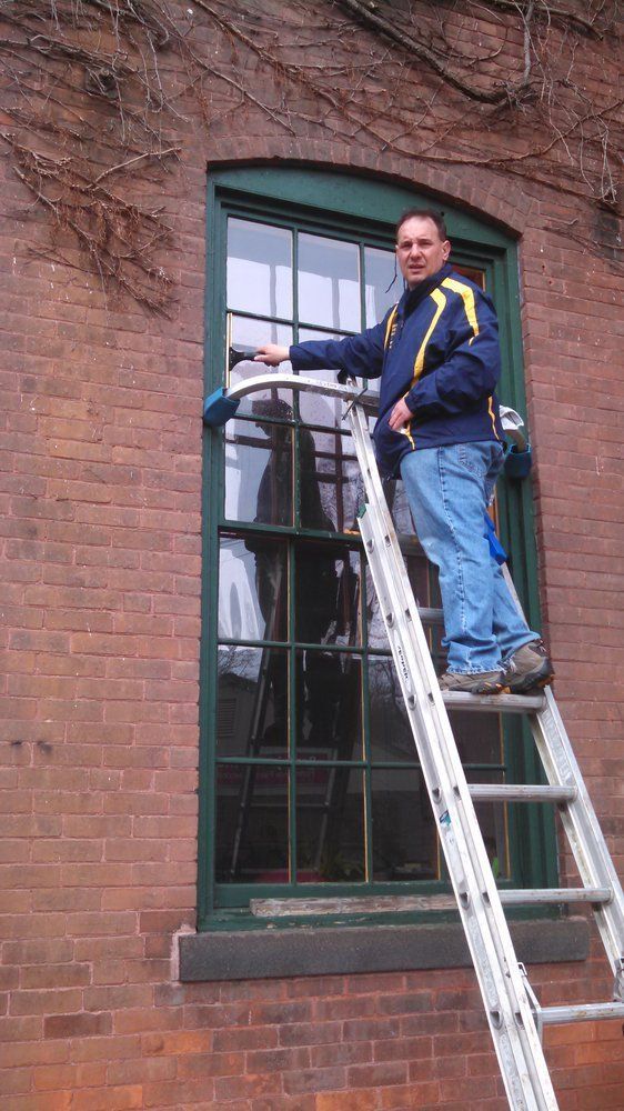 Owner Cleaning Commercial Windows Different Size Same Photo From Last One — Hadley, MA — Family Window Cleaning & Property Maintenance