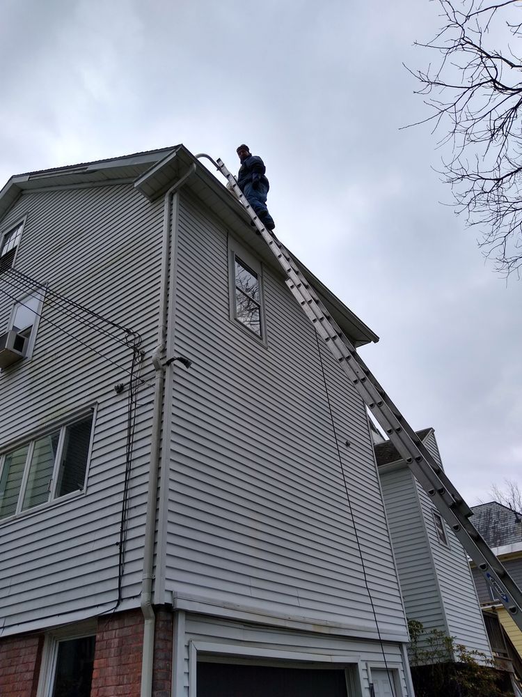 Person On Roof Top With Ladder — Hadley, MA — Family Window Cleaning & Property Maintenance