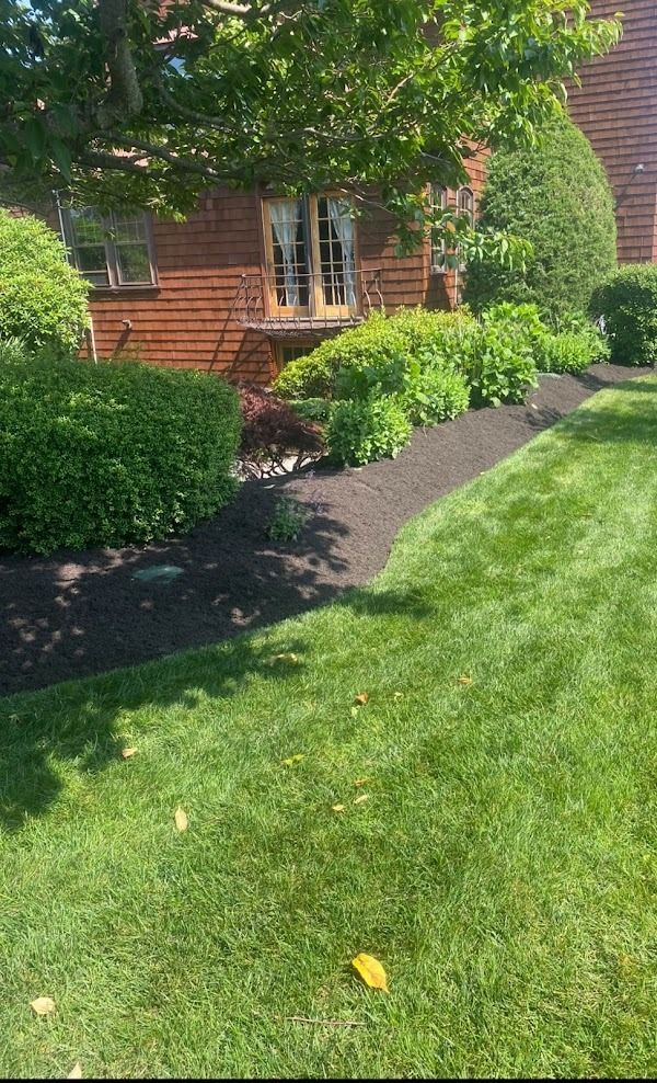 A house with a lush green lawn in front of it.