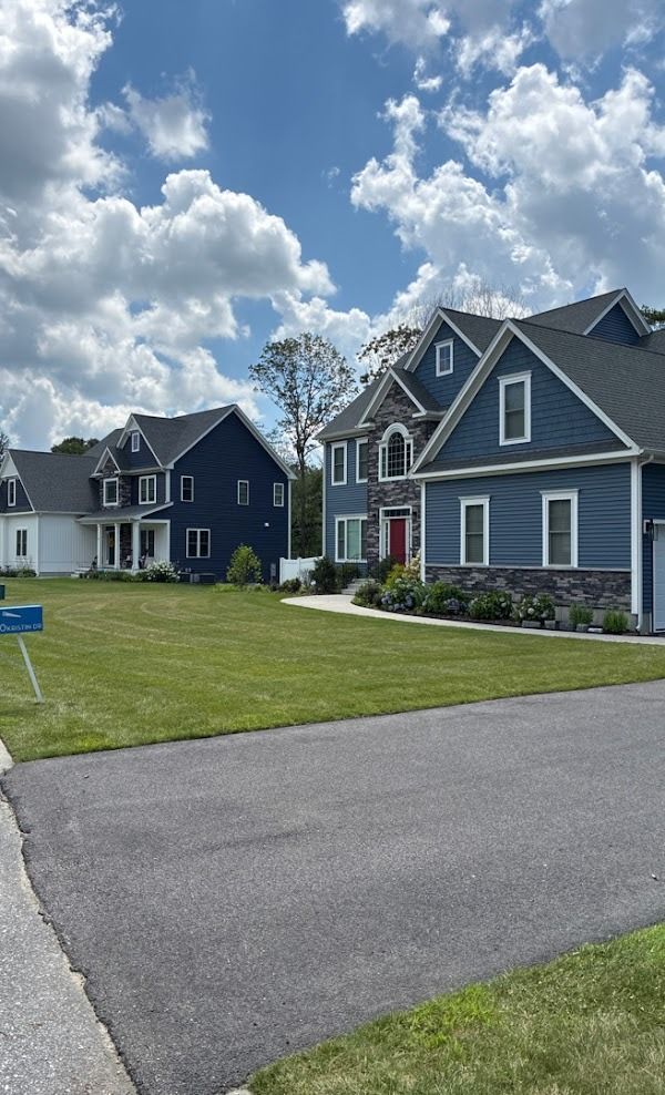 A row of blue houses sitting next to each other on a sunny day.