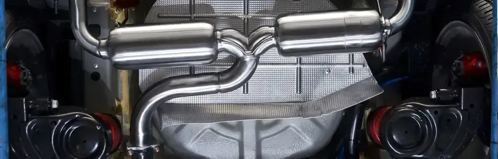 A Close Up of the Underside of a Car With Exhaust Pipes — Ace Exhaust Centre in Berserker, QLD
