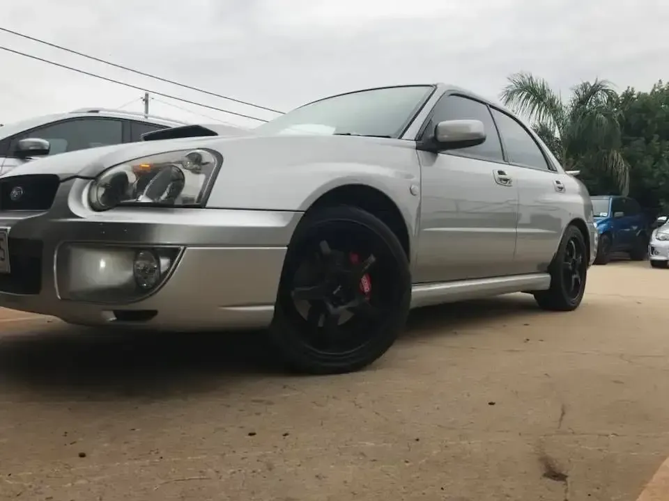A Silver Car is Parked in a Parking Lot Next to a White Car — Ace Exhaust Centre in Berserker, QLD