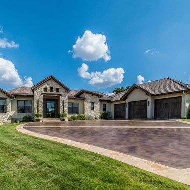Scarlet and Gray Power Washing - A large house with a driveway leading to it