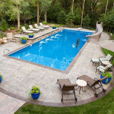 Scarlet and Gray Power Washing - A large swimming pool with a slide in the backyard