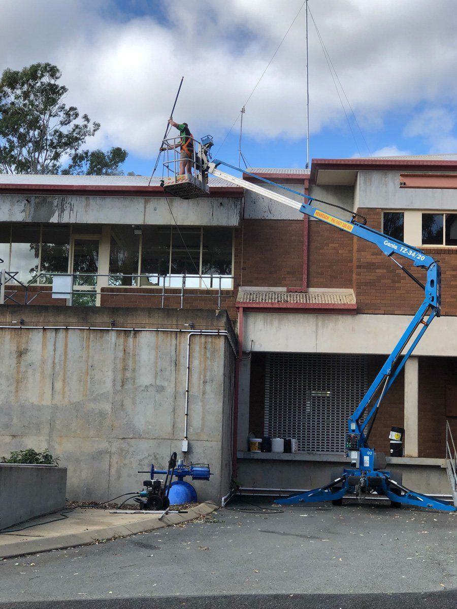 Worker in Cherry Picker Cleaning Gutters — Commercial Cleaners in Lismore