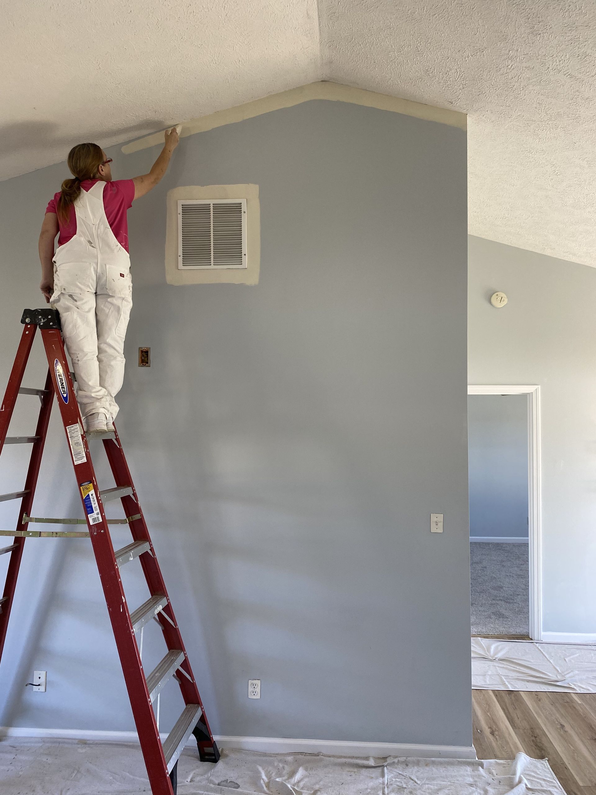 Architectural design tools: paint swatches, stone samples, and blueprints on a table.