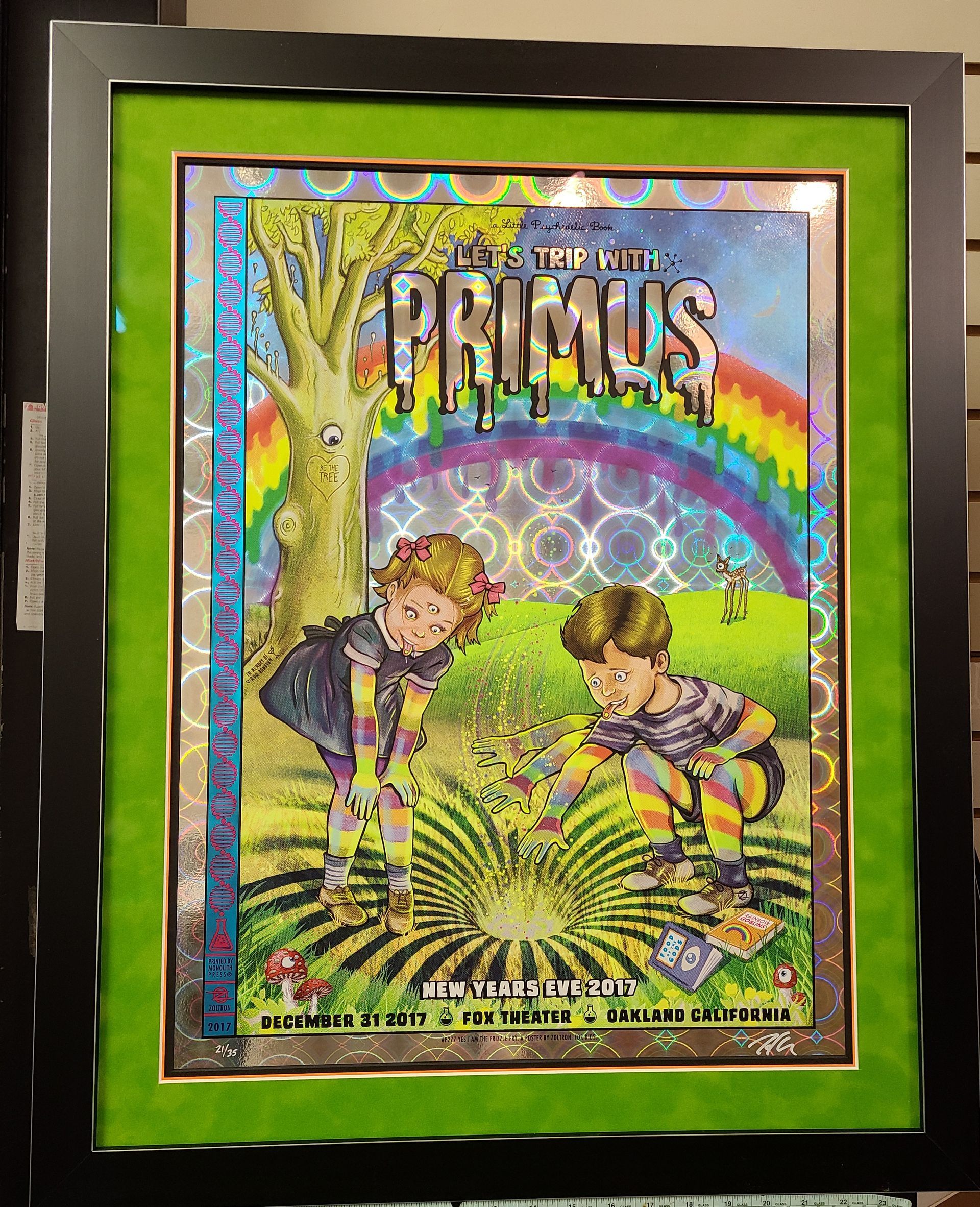 A framed picture of primus with a rainbow in the background