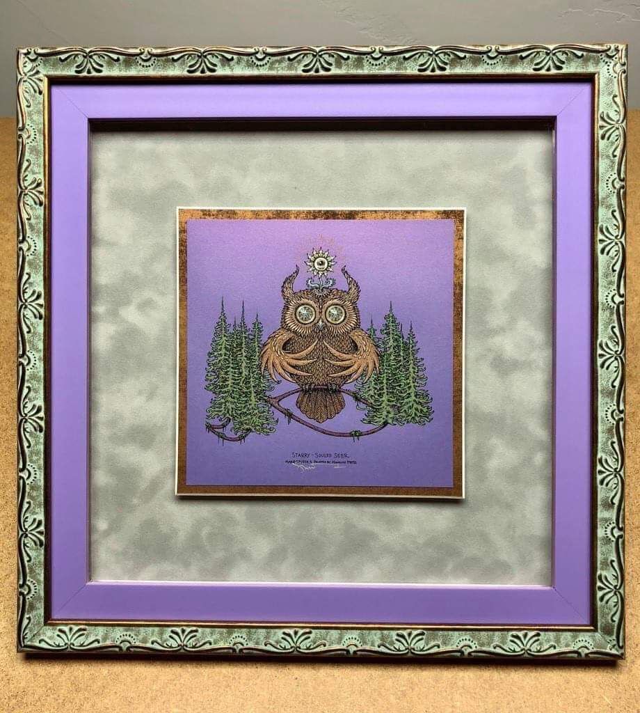 A picture of an owl in a purple frame