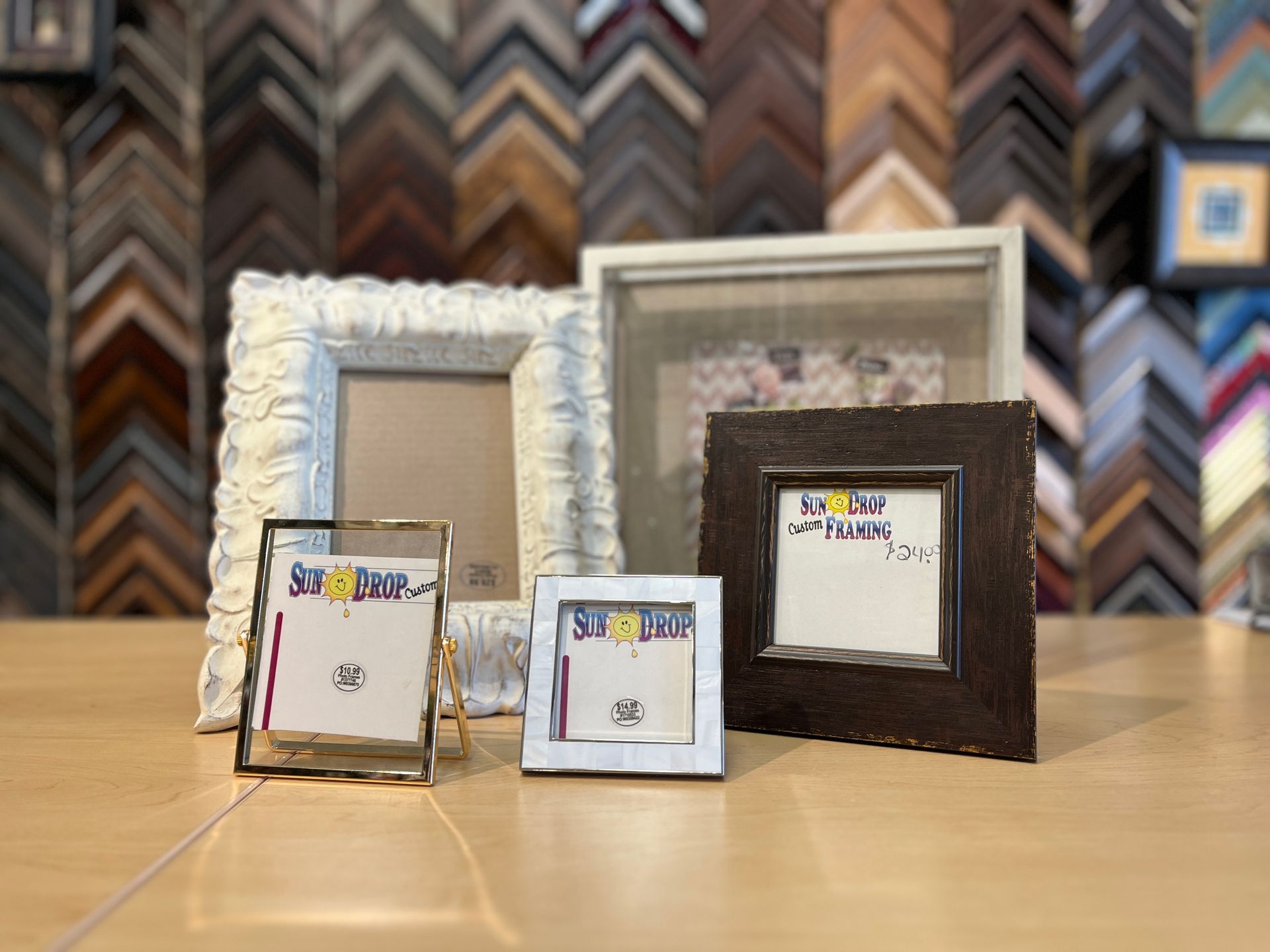 A group of picture frames are sitting on a table.