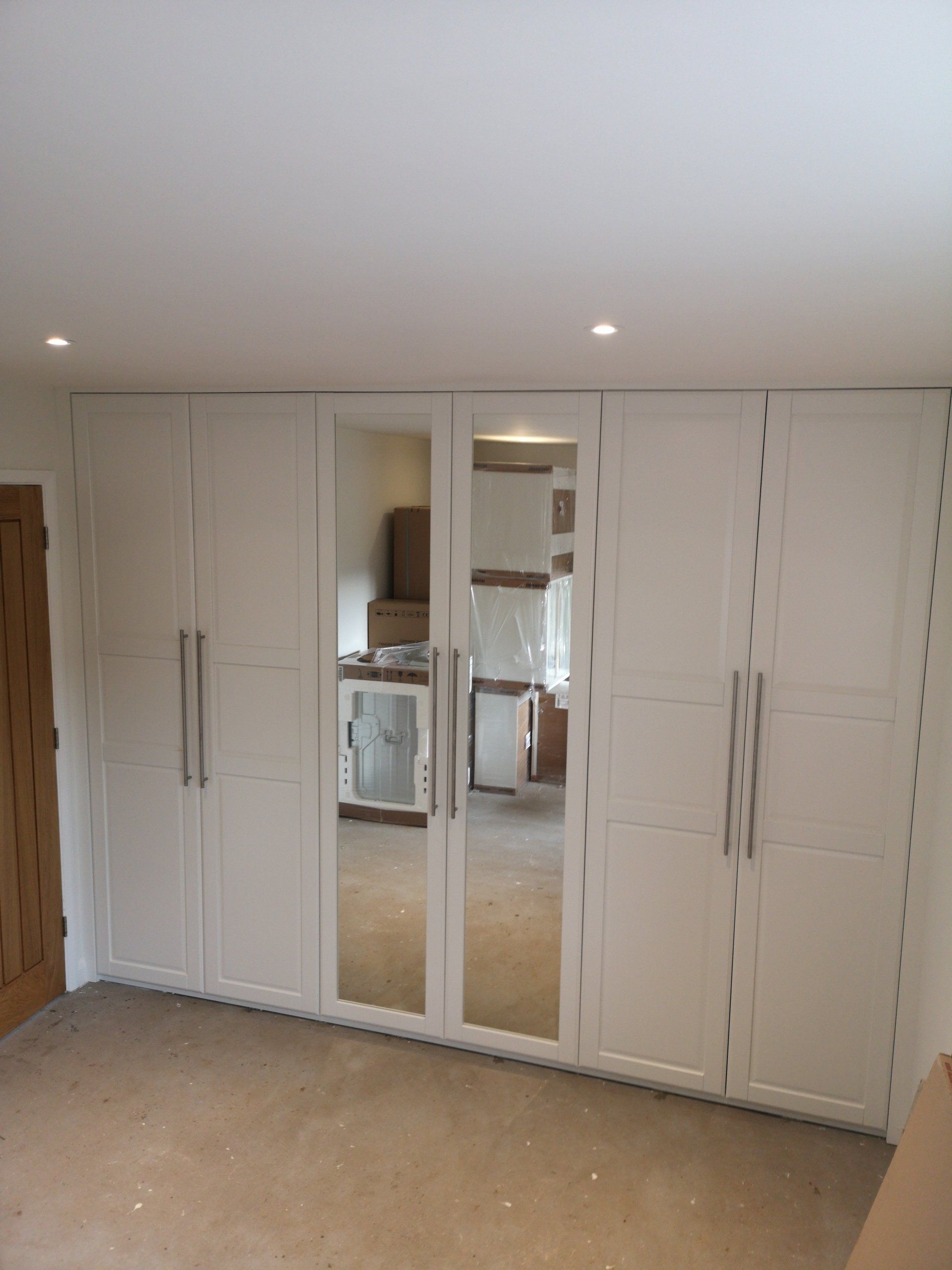 An Ikea wardrobe fully fitted from all to wall and floor to ceiling. Scribe fillets fitted all round and painted.