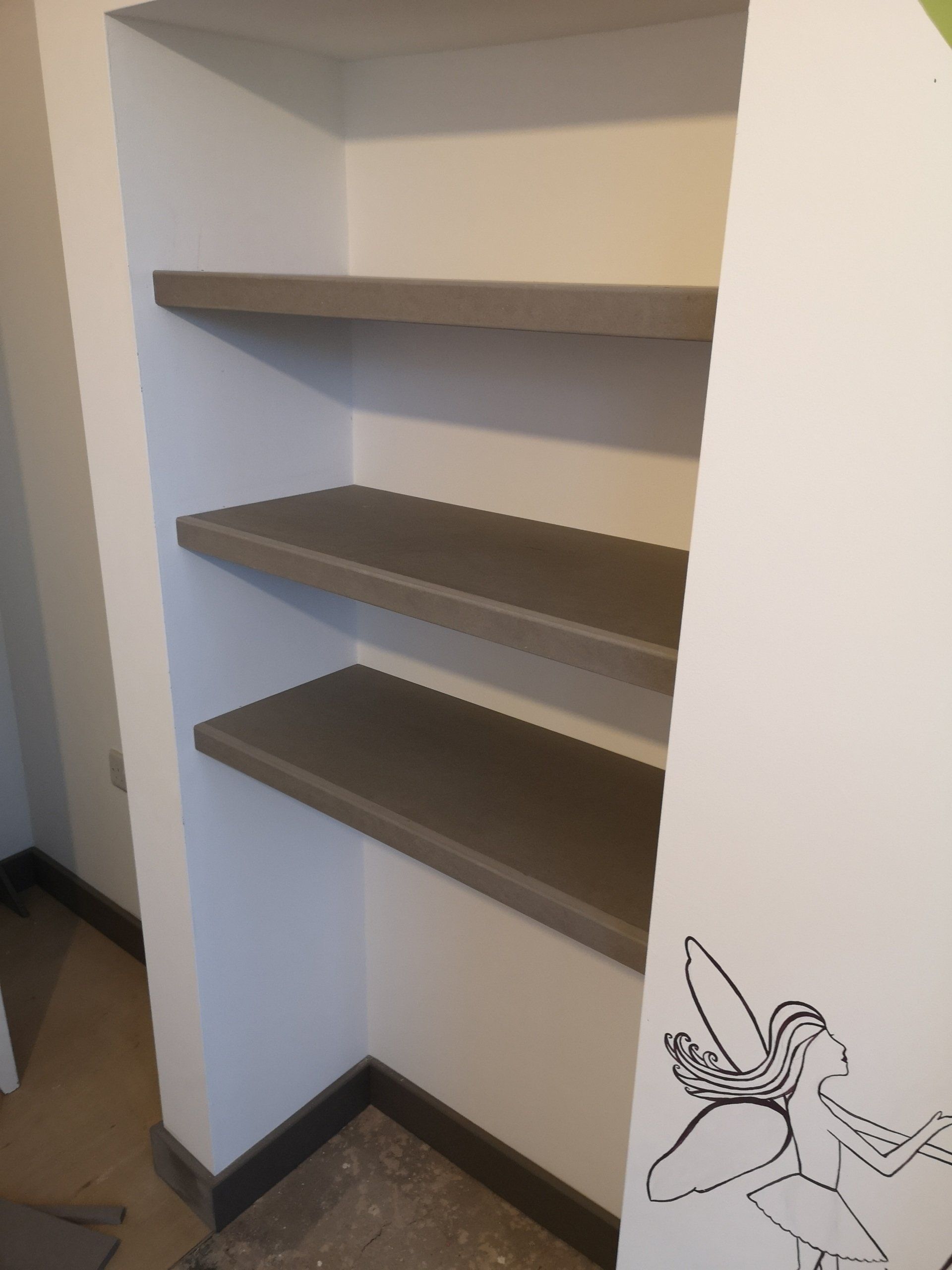 Grey Valchromat floating shelves fitted in alcove.