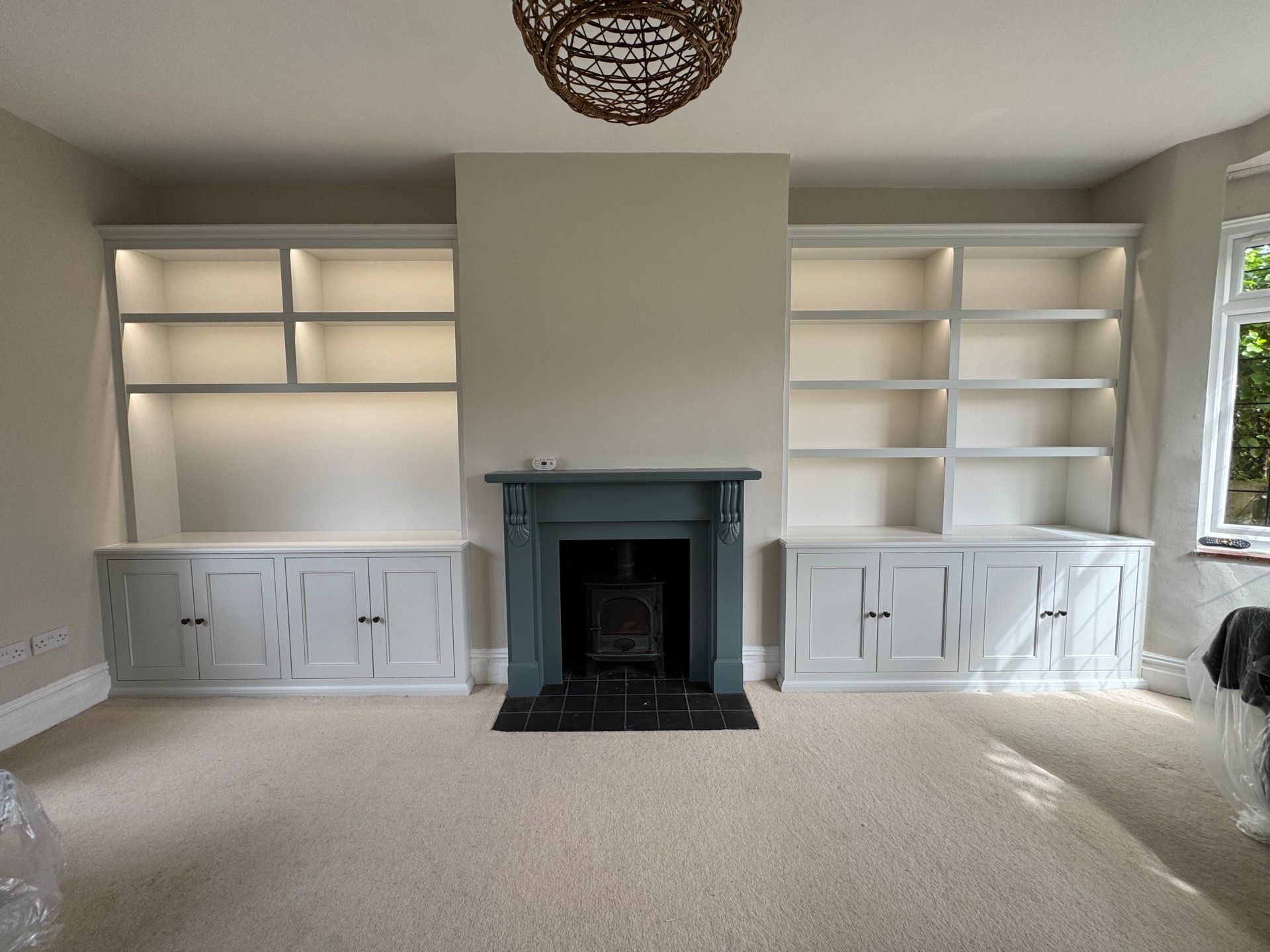A white bespoke made alcove unit with shaker doors.