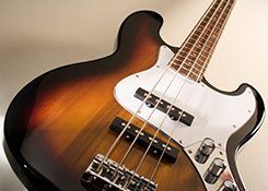 A brown and white bass guitar