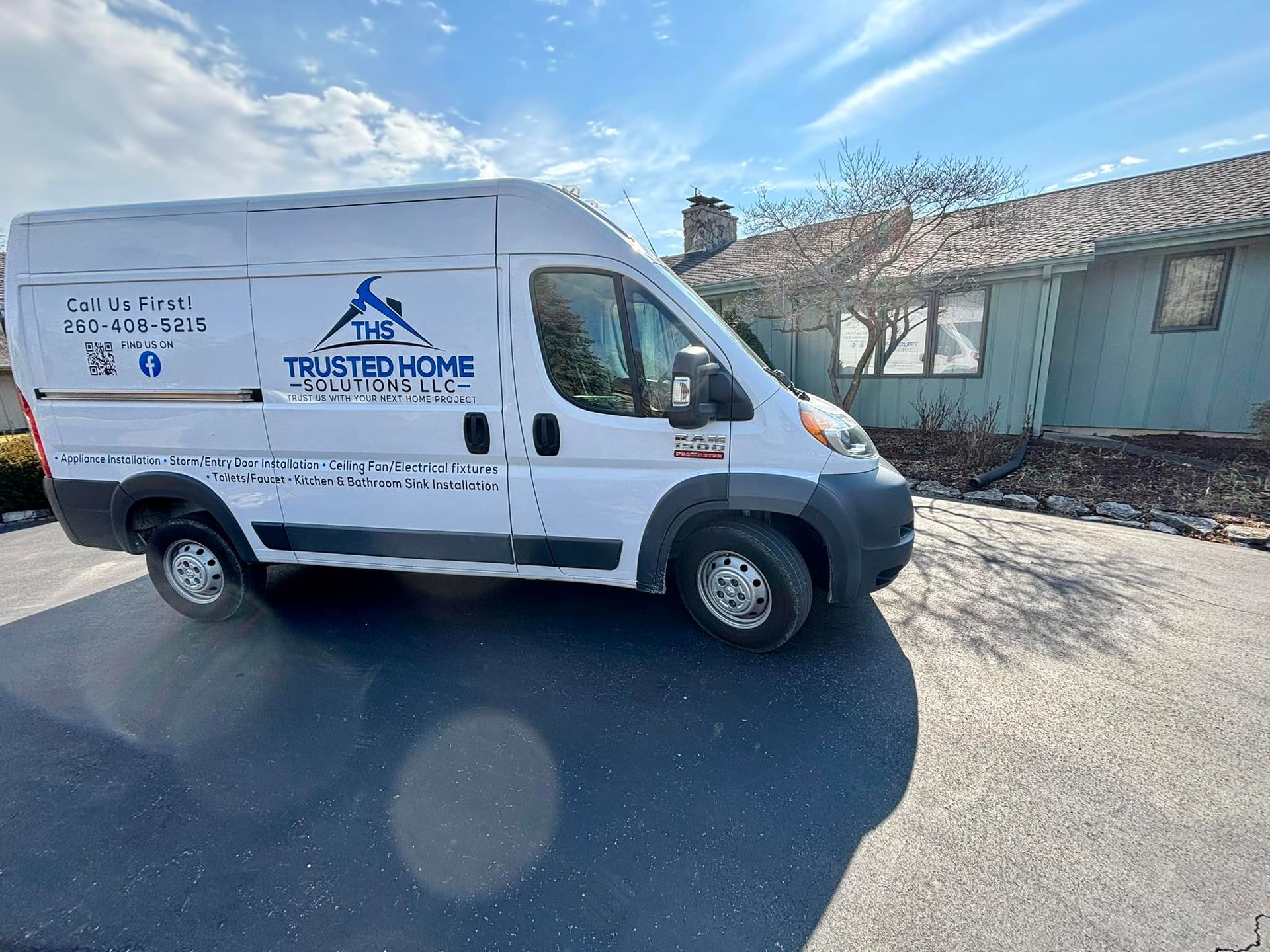 A white van is parked in front of a house.