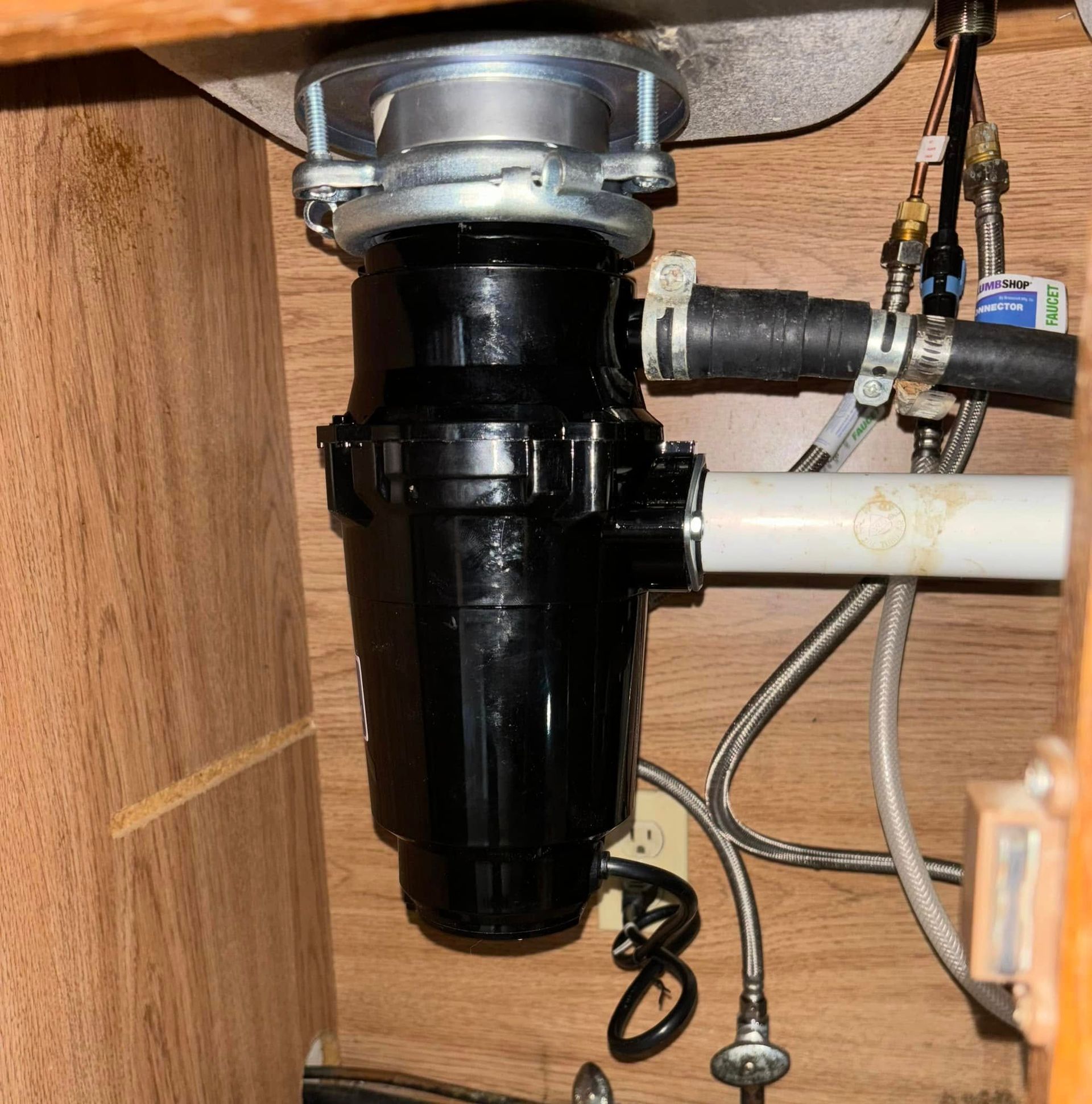 A sink with a garbage disposal underneath it
