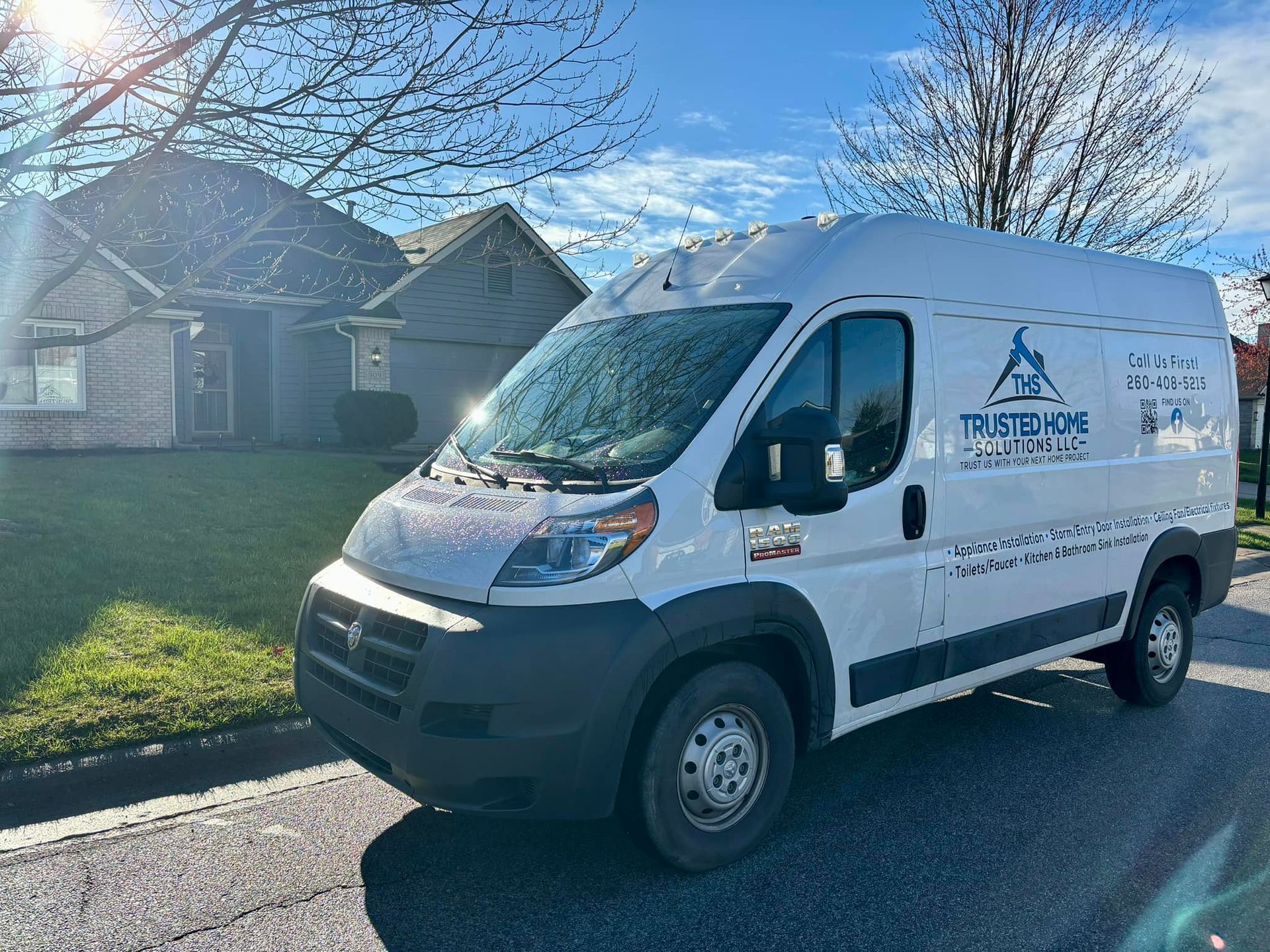 A white van is parked in front of a house.