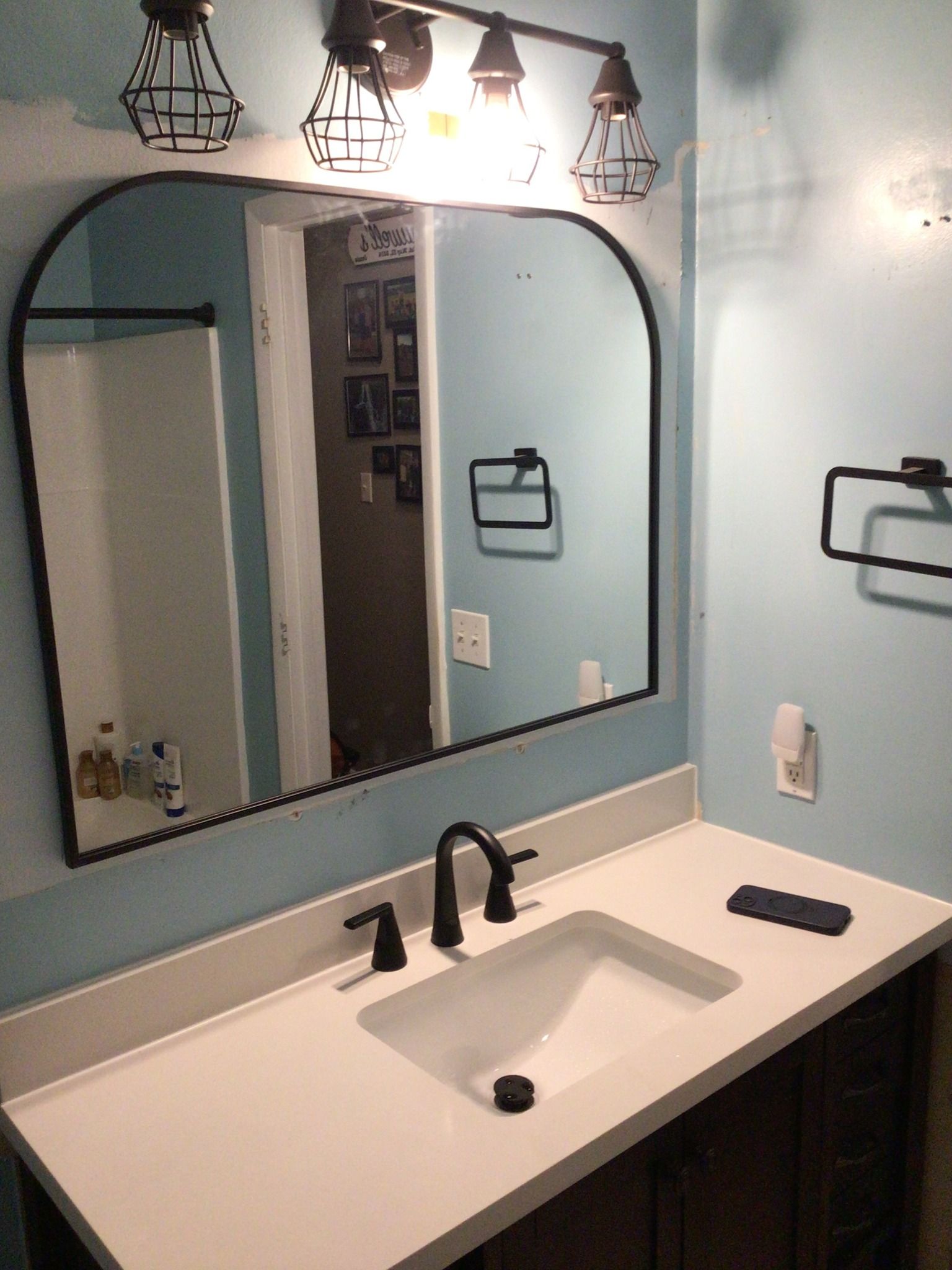 A bathroom sink with a large mirror above it.