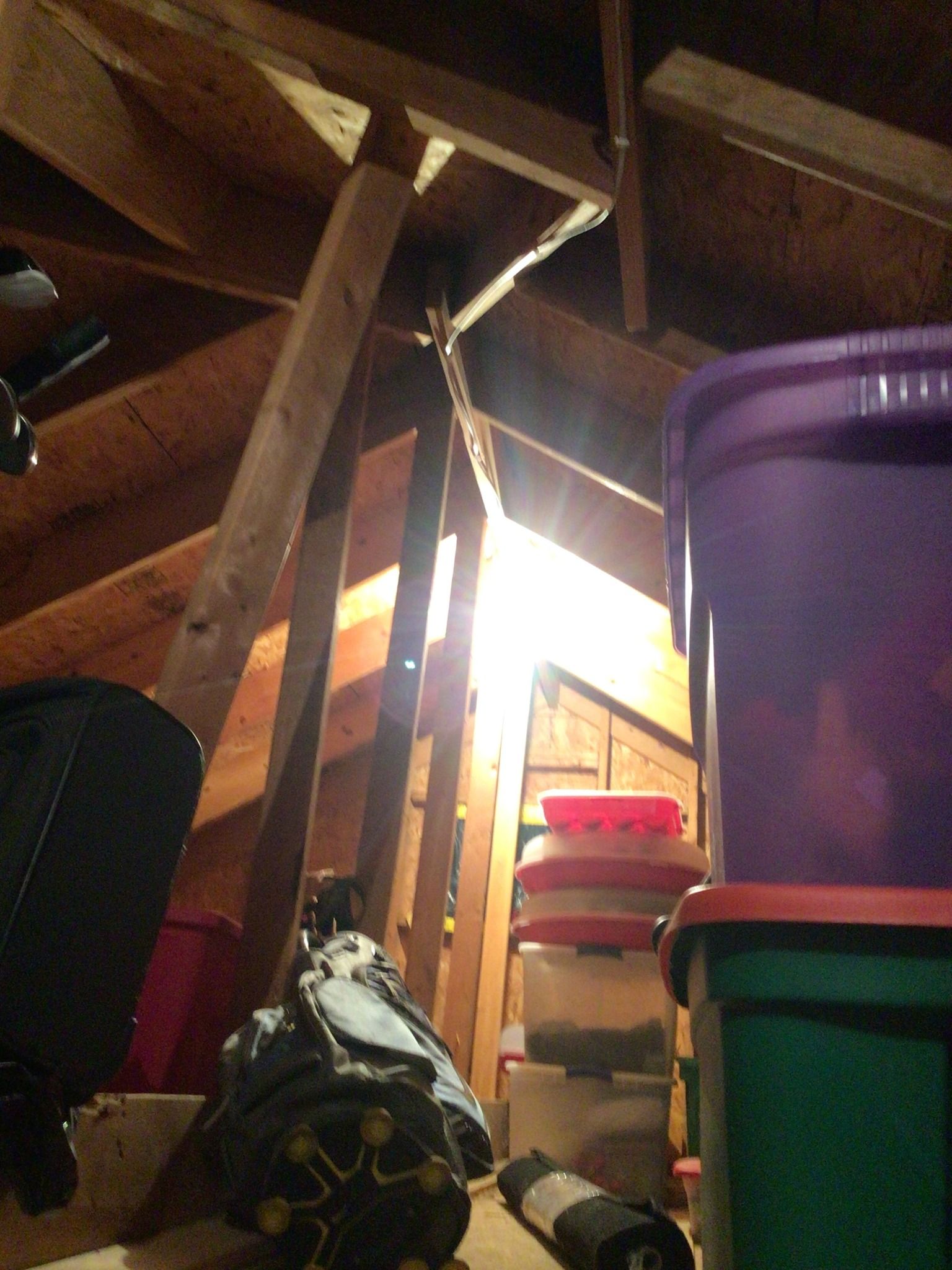 A bunch of boxes are stacked on top of each other in an attic
