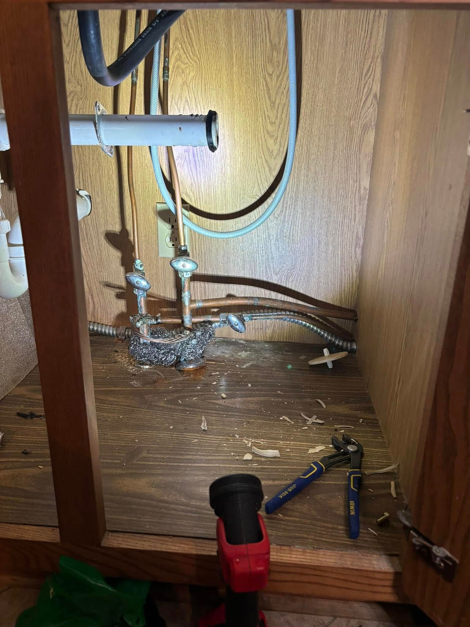 A bathroom sink with a lot of wires coming out of it.