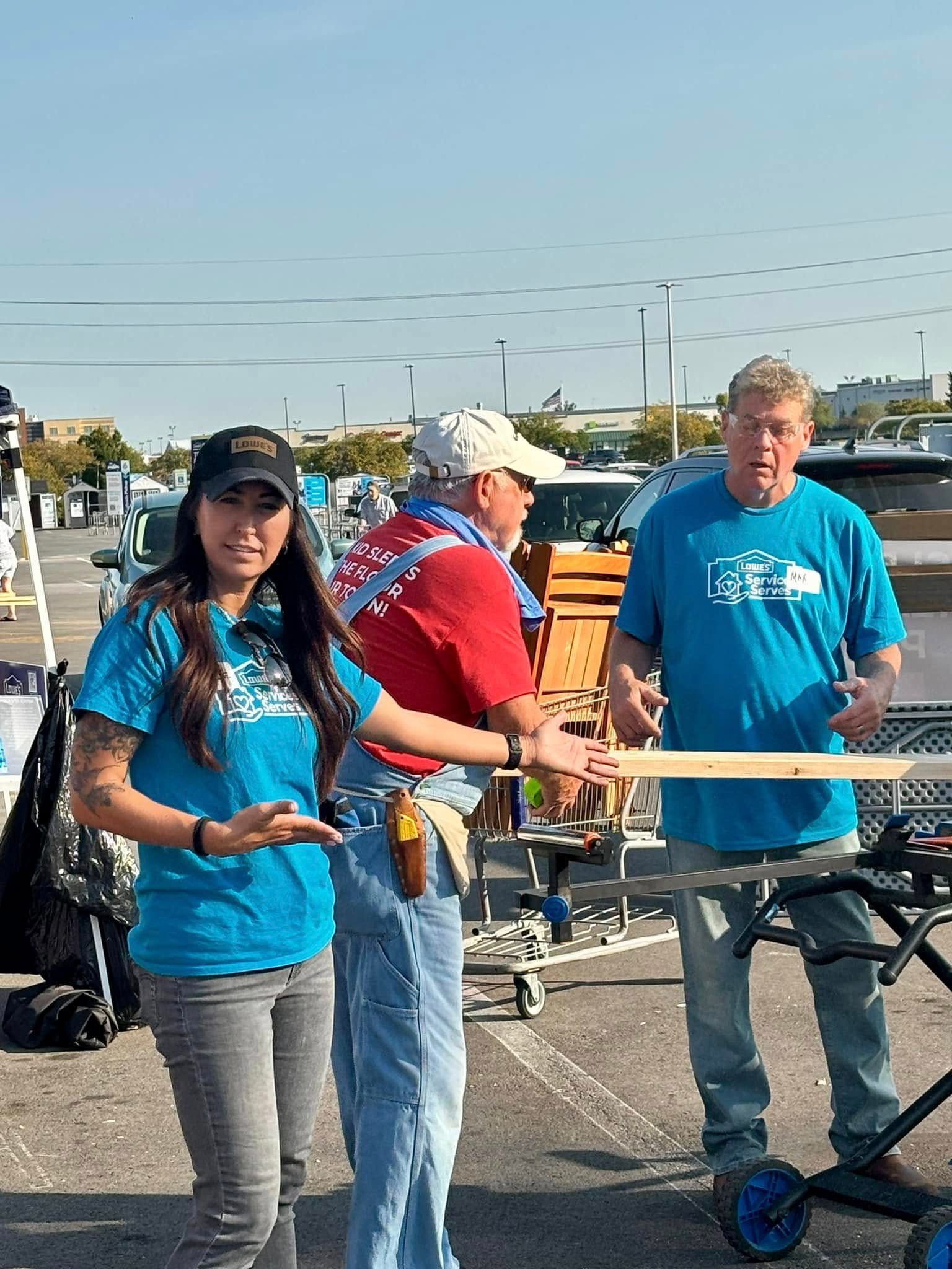 A man and a woman are standing next to each other in a parking lot.