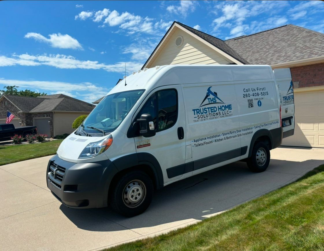 A white van is parked in front of a house.