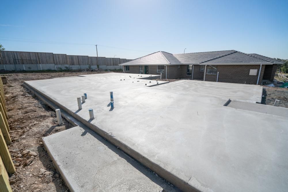 A House Is Being Built On A Concrete Foundation — Tuscany Concreting In Cannonvale, QLD