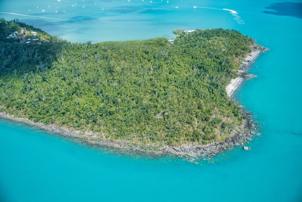 An Aerial View Of A Small Island In The Middle Of The Ocean — Tuscany Concreting In Cannonvale, QLD