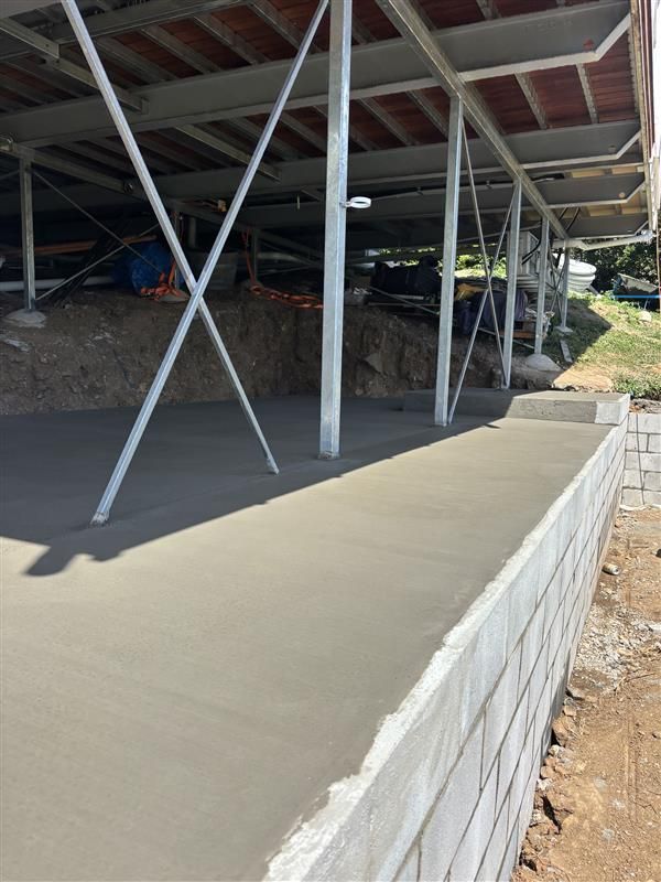 A Group Of Construction Workers Are Pouring Concrete Into The Ground — Tuscany Concreting In Proserpine, QLD