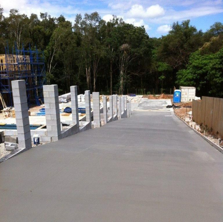 Concrete Walkway With A Row Of Bricks On The Side Of It — Tuscany Concreting In Whitsundays, QLD
