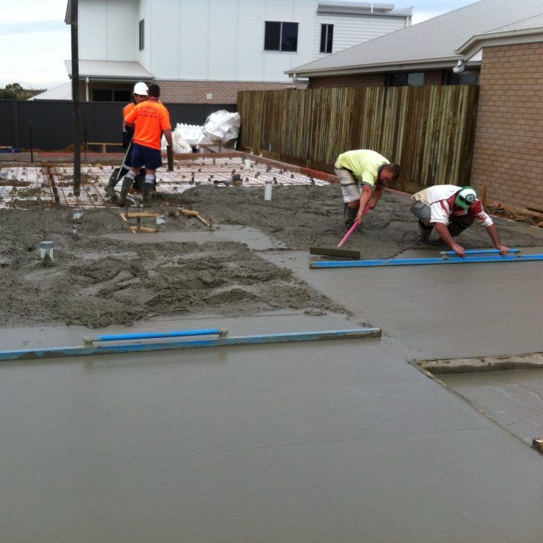 Group of Construction Workers Are Working On A Concrete Floor — Tuscany Concreting In Airlie Beach, QLD