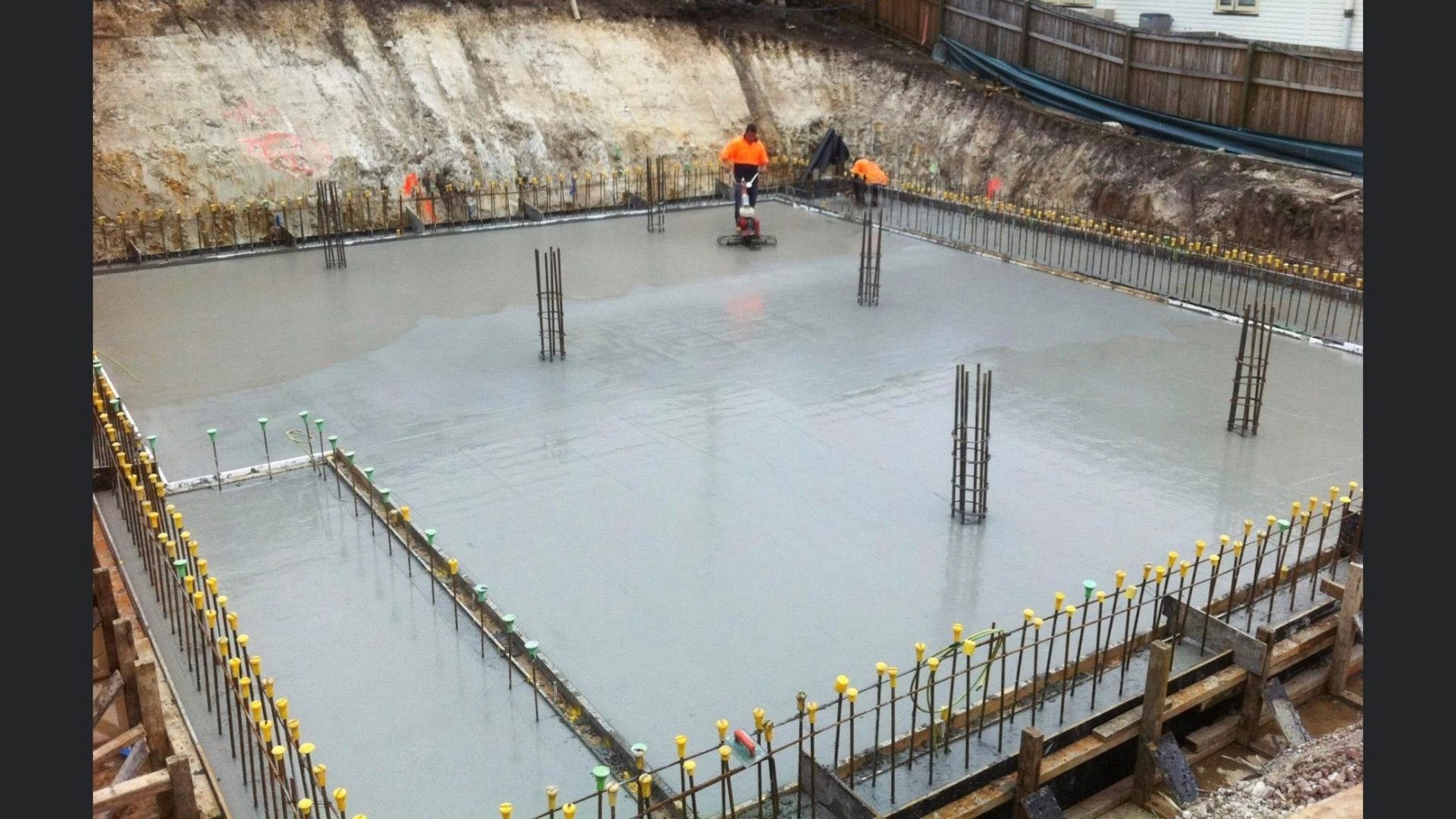 A Large Concrete Slab Is Being Poured In A Construction Site — Tuscany Concreting In Whitsundays, QLD