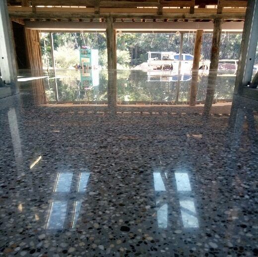 A Close Up Of A Shiny Concrete Floor With A Window In The Background — Tuscany Concreting In Airlie Beach, QLD